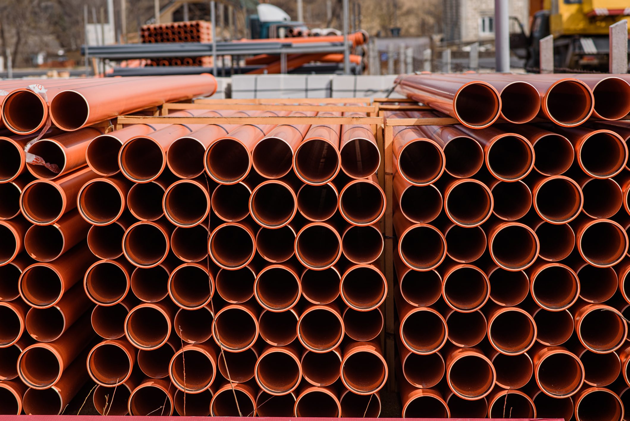 A close up sewer pipes prepared for installation.